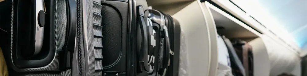 Luggage in overhead bin on airplane